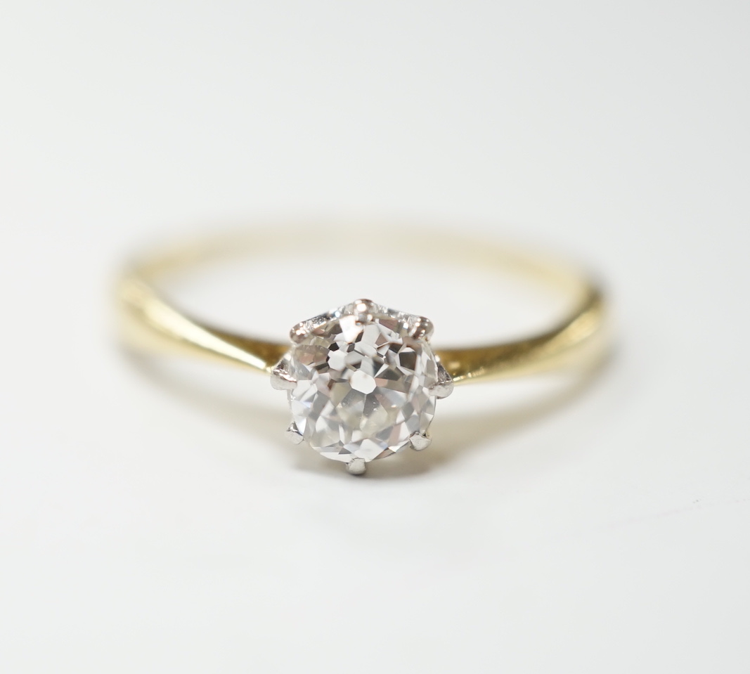 A yellow metal and solitaire diamond ring, stone diameter 5.1mm, size L, gross weight 1.8 grams.